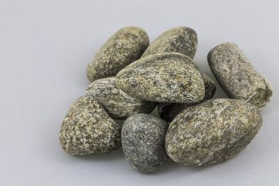 Close-up of pebbles against white background