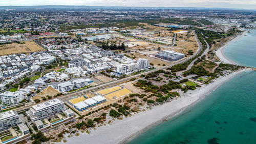 High angle view of buildings by sea