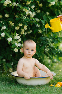 Portrait of cute baby boy in bathtub