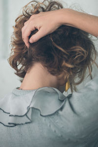 Rear view of woman with hand in hair