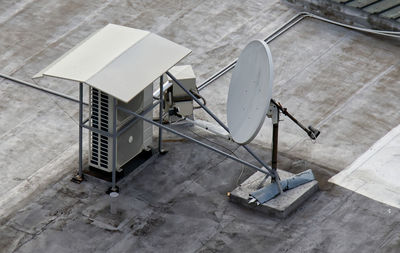 High angle view of telephone booth on table against wall