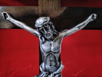 Close-up of statue against red wall