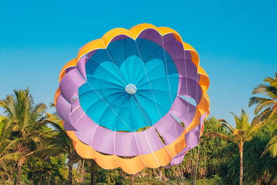 Low angle view of hot air balloon against clear blue sky