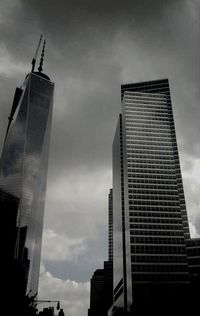 Low angle view of buildings against cloudy sky