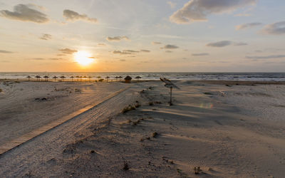 Scenic view of beach against sky during sunset