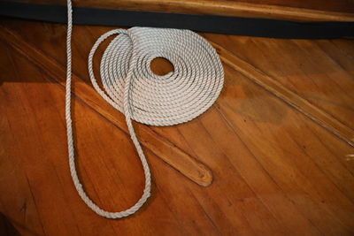 High angle view of rope on hardwood floor