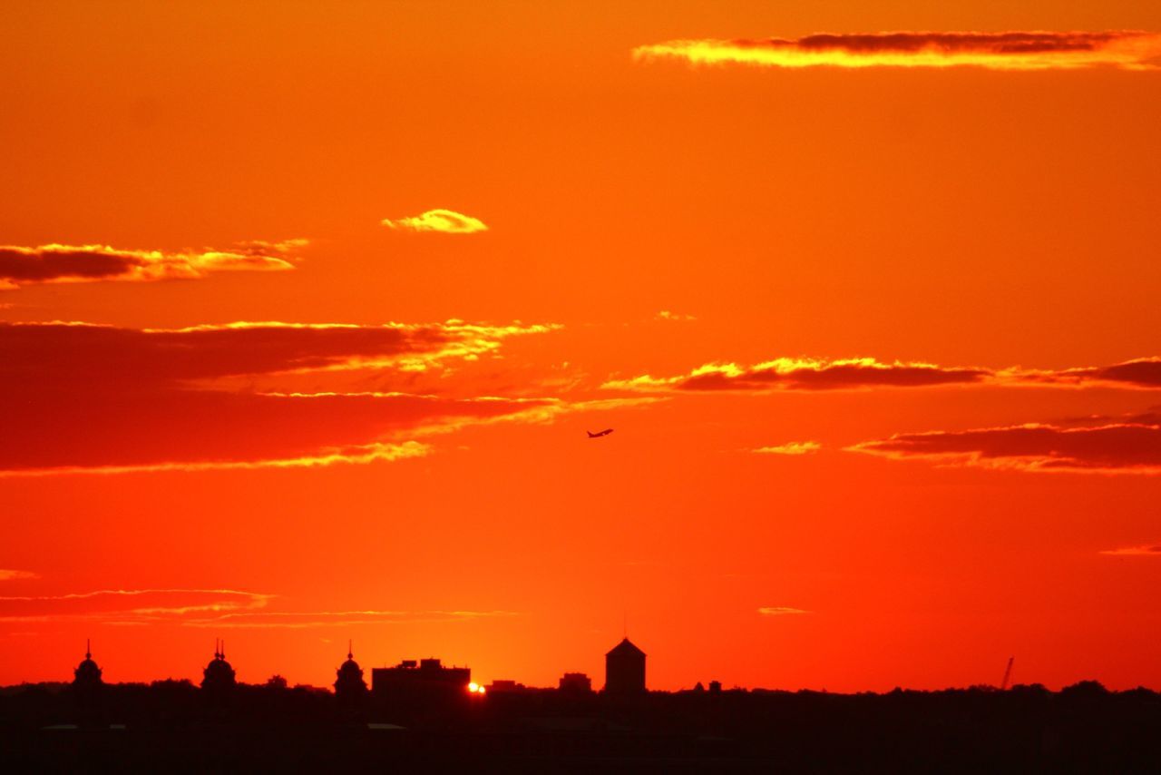 sunset, silhouette, orange color, scenics, beauty in nature, sun, sky, tranquil scene, idyllic, tranquility, nature, dramatic sky, building exterior, landscape, built structure, romantic sky, cloud - sky, outline, architecture, moody sky