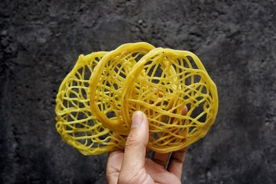 Midsection of man holding yellow leaf