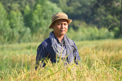 Portrait of farmer standing on agricultural field