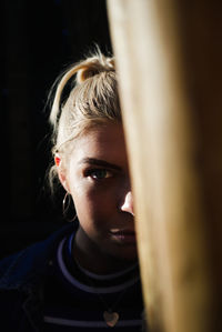 Close-up portrait of beautiful woman in darkroom