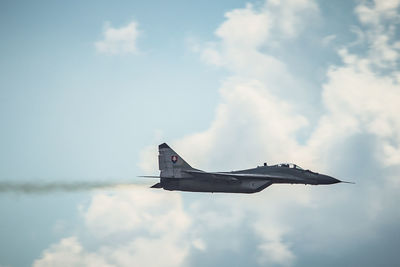 Low angle view of airplane flying against sky