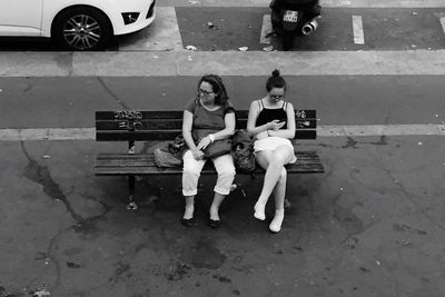 Full length of siblings sitting outdoors