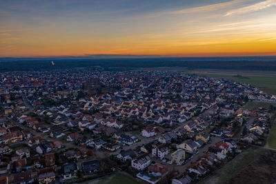 High angle shot of townscape against sky at sunset