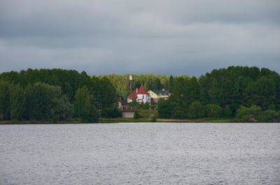 Scenic view of lake by building against sky