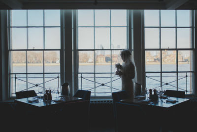 Woman working on glass window