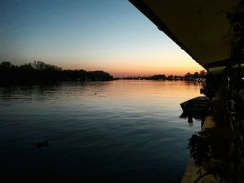 Scenic view of lake against sky at sunset