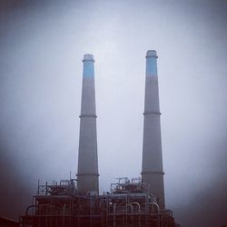 Low angle view of factory against clear sky