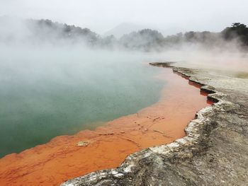 Scenic view of geyser against sky