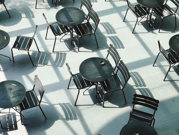 High angle view of empty chairs and tables at restaurant