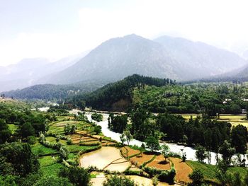 High angle view of agricultural field against cloudy sky