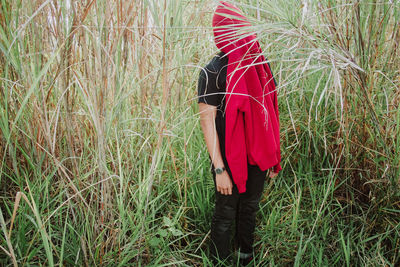 Low section of woman standing on field