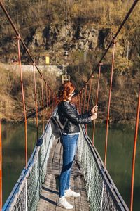 Rear view of man on footbridge