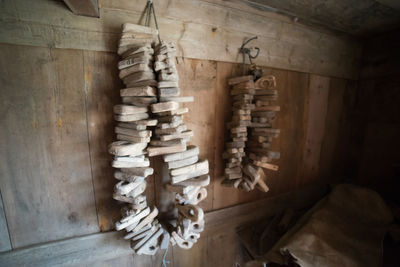 Close-up of clothes hanging on wood at home