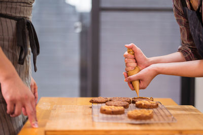 Midsection of woman preparing food on table