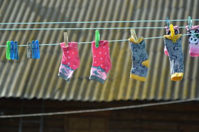 Low angle view of clothes drying on clothesline against wall