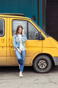 Full length of woman standing by car