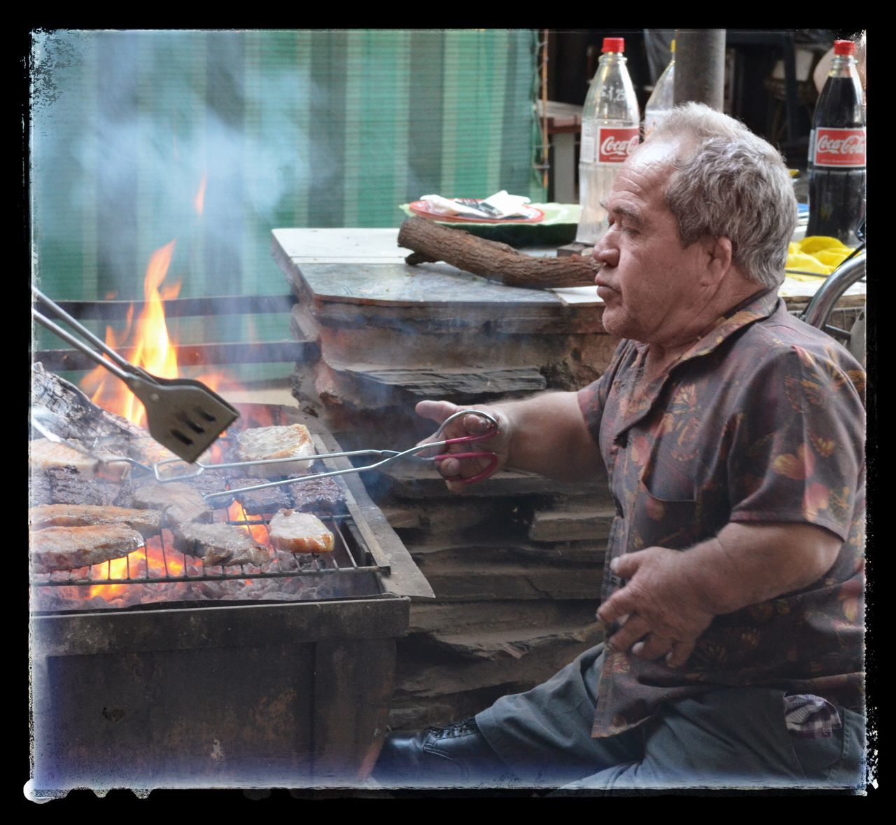 flame, heat - temperature, burning, barbecue grill, smoke - physical structure, preparation, barbecue, real people, grilled, food, one person, meat, preparing food, food and drink, outdoors, concentration, men, day, freshness, people