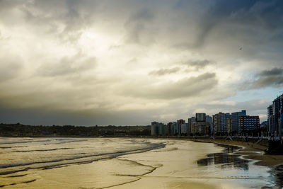 Buildings by city against sky