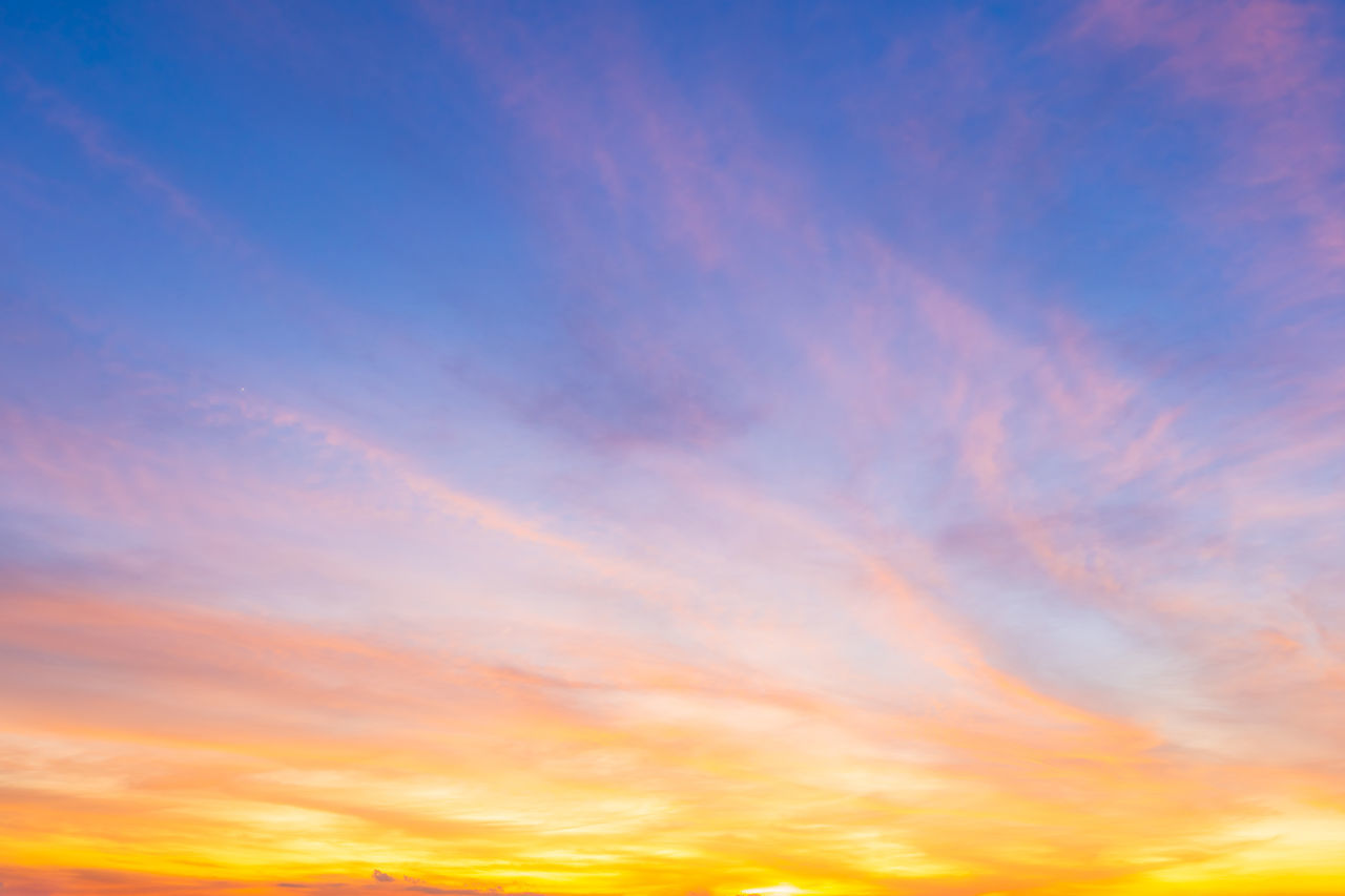 sky, sunset, afterglow, cloud, red sky at morning, beauty in nature, dramatic sky, scenics - nature, horizon, nature, tranquility, multi colored, tranquil scene, orange color, cloudscape, sunlight, idyllic, environment, vibrant color, dawn, backgrounds, blue, no people, sun, yellow, moody sky, twilight, atmosphere, outdoors, urban skyline, evening, landscape, light - natural phenomenon, awe, romantic sky, atmospheric mood, summer, copy space, daytime, low angle view, abstract, bright, sunbeam