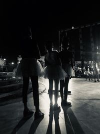 Group of people by the road at night