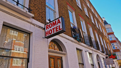 Low angle view of text on building against sky