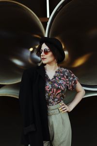 Fashionable young woman wearing sunglasses while standing outdoors