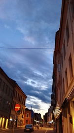 Buildings in city against cloudy sky