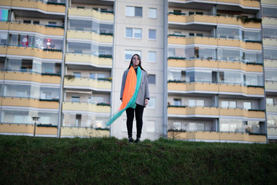 Full length of man standing in front of building