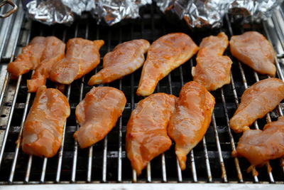 High angle view of meat on barbecue grill