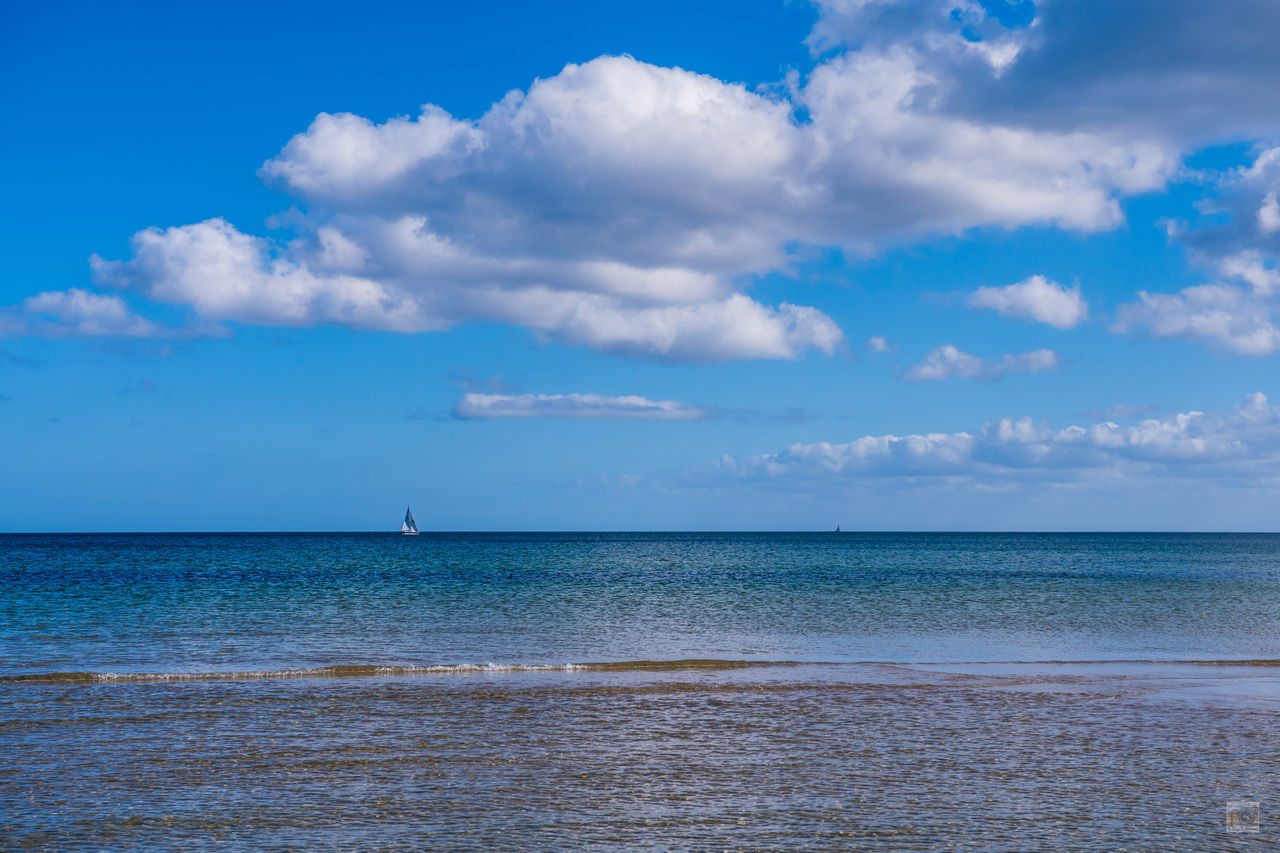 SCENIC VIEW OF BEACH AGAINST BLUE SKY