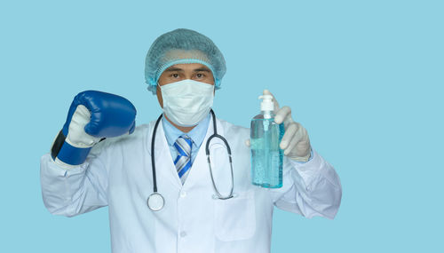 Man wearing mask against blue background