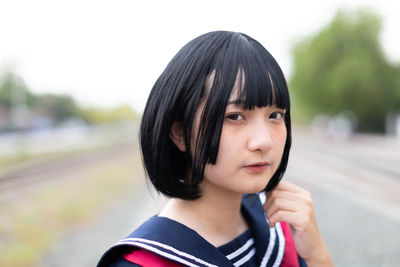 Portrait of young woman standing outdoor