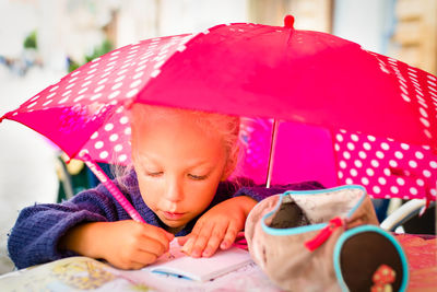 Portrait of happy girl playing with umbrella