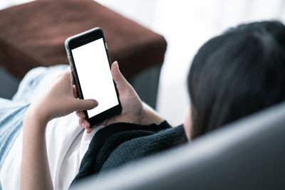 Midsection of man using mobile phone