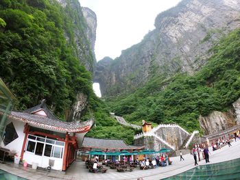 Group of people on mountain against buildings