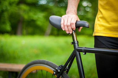 Cyclist with his bike, close up. outdoor photography. you can see his hands and the wheel.