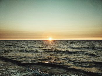 Scenic view of sea against sky at sunset