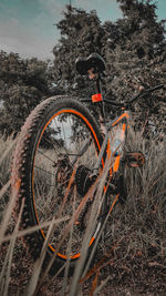 Close-up of bicycle wheel on field