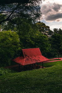 Traditional windmill on field against sky