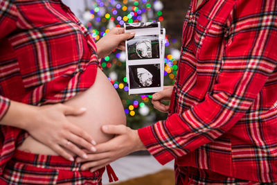 Midsection of man using mobile phone